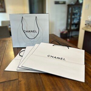5 authentic Chanel large paper gift bags, 1 piece of Chanel tissue, 1 ribbon